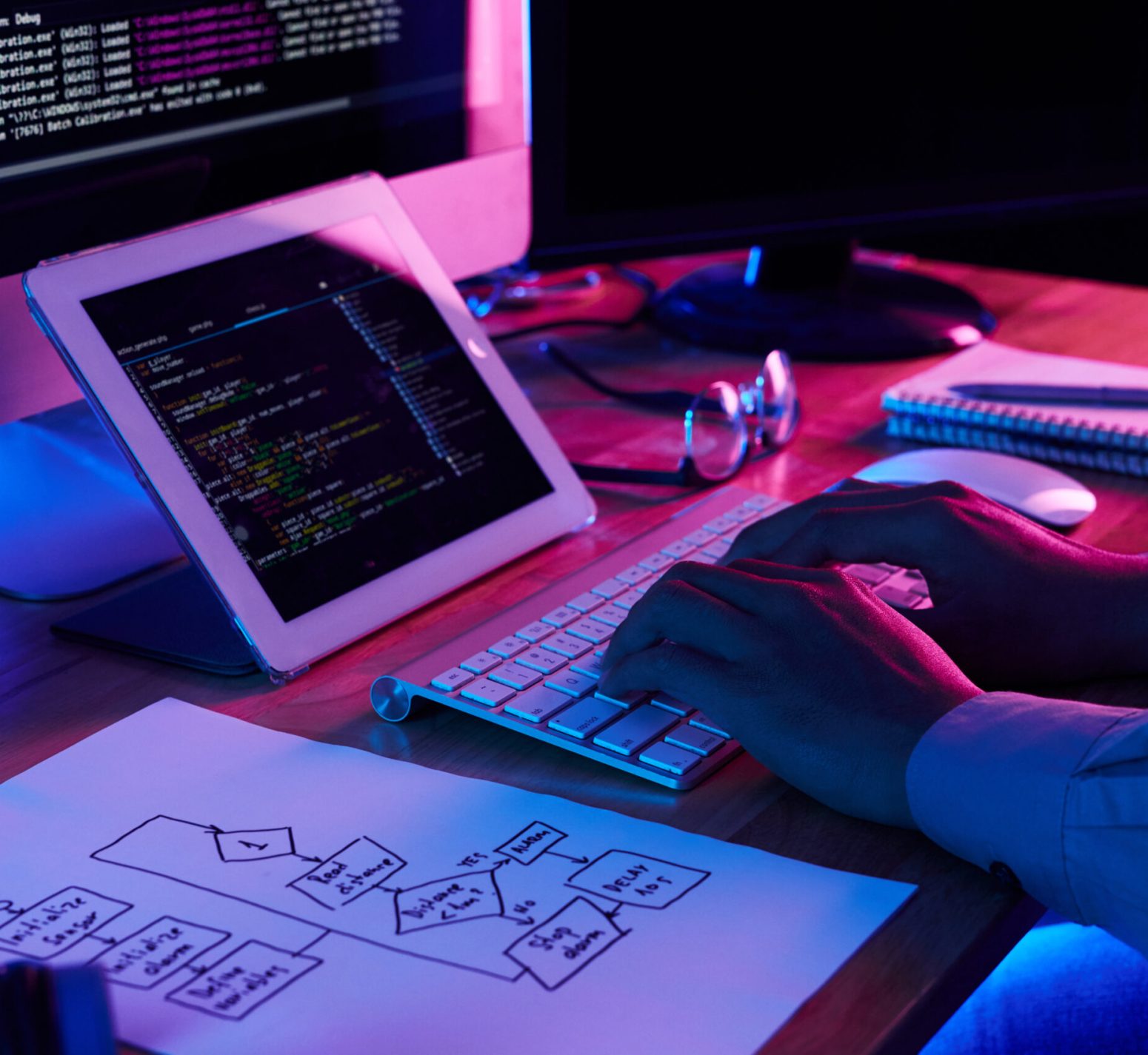 Close-up image of programmer working at his desk in office
